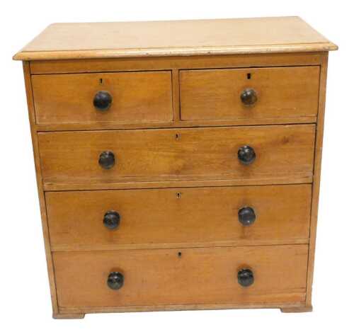 An early 20thC light oak chest of two short and three long drawers, with later knob handles on...