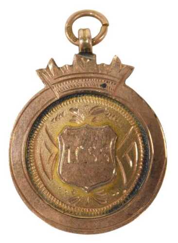 A 9ct gold fob, of circular form with central shield, initialled ICSS, marked verso Victor Nandi...