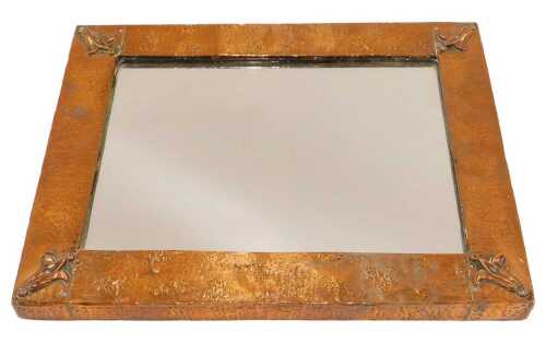 A very early 20thC Liberty style Arts & Crafts copper mirror, of rectangular form, with part...