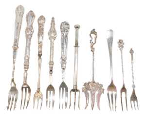 Ten silver and other pickle and serving forks, to include one with entwined stem and cross top,...