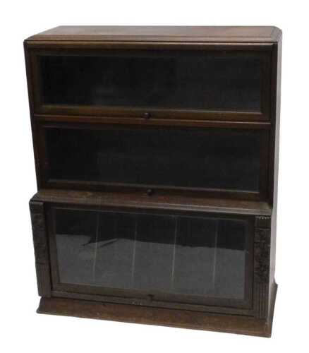 An early 20thC Wernicke style bookcase, the upper section with two folding open bookshelves...