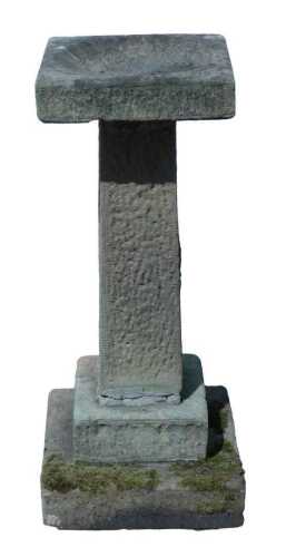A 20thC stone birdbath, the square top with dish centre on tapering stem terminating in stepped...