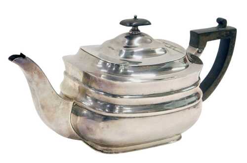 A George V silver teapot, of cape form with ebonised angular thumb mould handle and oval knop,...