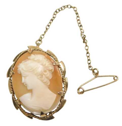 A 9ct gold shell cameo brooch, the figure looking sinister, in a six claw mounted setting, with...
