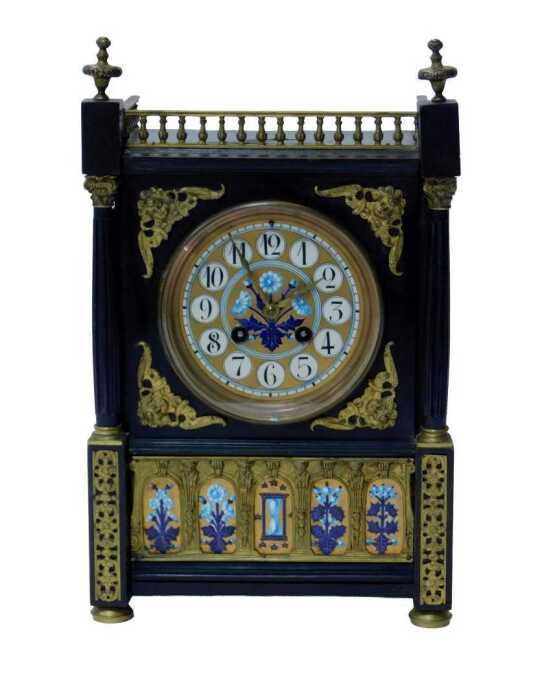 An early 20thC Aesthetic movement clock, in a Gothic Revival case, with painted enamel dial with...