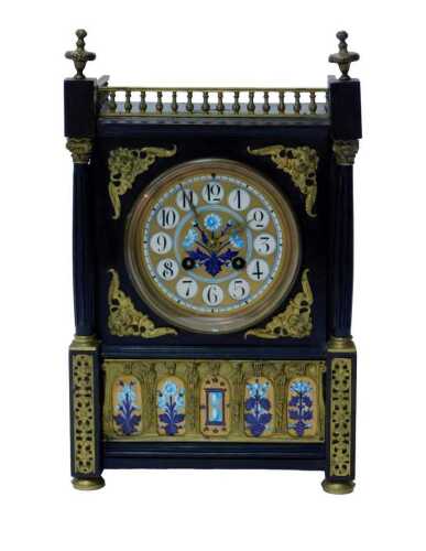 An early 20thC Aesthetic movement clock, in a Gothic Revival case, with painted enamel dial with...
