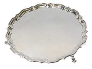 A George V silver salver, of circular form with a piecrust border, raised on three hoof feet,... - 2