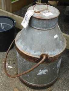 V - A small aluminium milk churn, with an iron swing handle to the top and sides, of shouldered...