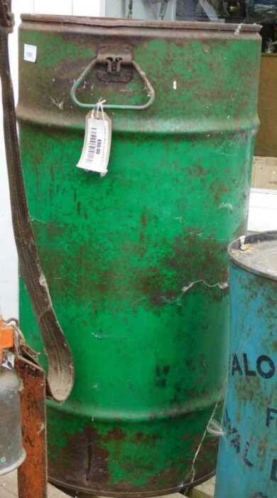 V - An early 20thC oil drum, of cylindrical form, with swing handles, partially painted green, 70cm...