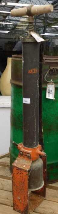 V - An early 20thC Eclipse iron pump, with cylindrical articulated wooden handle, partially painted...