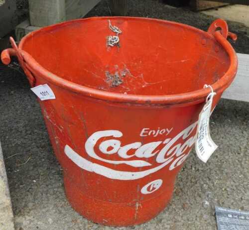 V - A late 20thC fire bucket, painted with a Coca-Cola emblem in red and white, with a swing handle,...