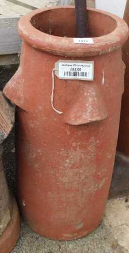 V - An early 20thC clay-baked chimney pot planter, with open sections to the cylindrical body, 67cm...