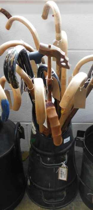 V - Various walking sticks, contained in a two-handled coal bucket, partially painted with flowers,...