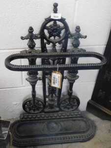 V - An early 20thC Coalbrookdale-style cast-iron stick stand, with an elaborate back, oval section,...