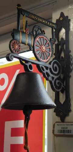 V - A late 20thC Joseph Brewer and Sons advertising steam tractor metal bell, with wall-hanging,...