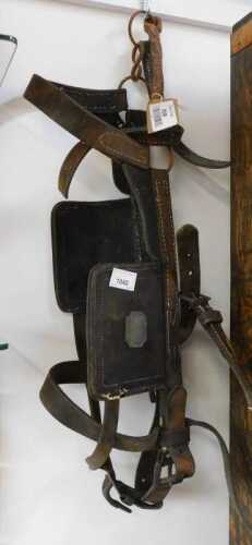 V - A leather horse tack, with metal sections and stitching, 58cm high. NB. VAT is payable on the...