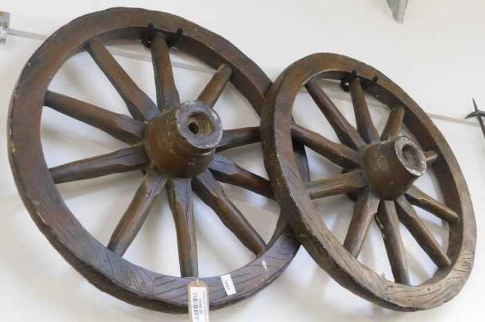 V - Two reproduction wooden cart wheels, 68cm diameter. NB. VAT is payable on the hammer price....