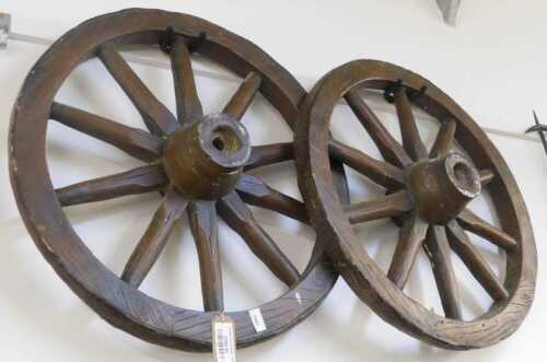 V - Two reproduction wooden cart wheels, 68cm diameter. NB. VAT is payable on the hammer price....