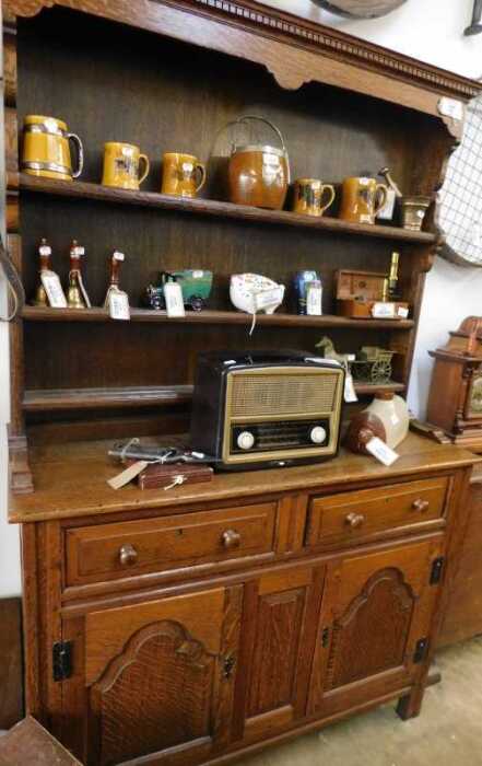 V - A 20thC oak dresser, of small proportion, the dentil top raised above an open Delft rack of...