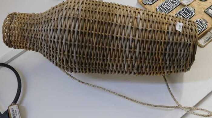 V - An early 20thC wicker eel basket, of shouldered form, with rope handle, 75cm high. NB. VAT is...