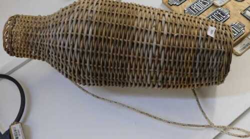 V - An early 20thC wicker eel basket, of shouldered form, with rope handle, 75cm high. NB. VAT is...