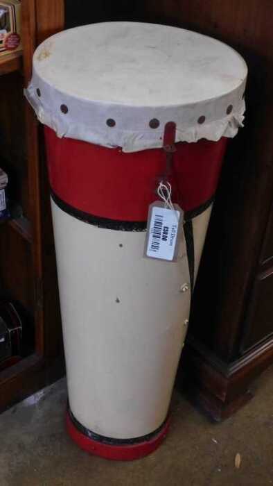 V - A 20thC tribal style drum, of circular form, in pink and red, with part studded top, 71cm high,...