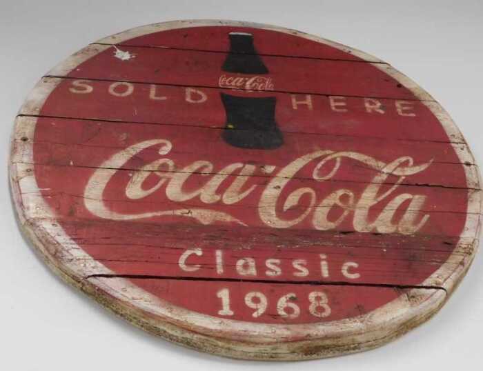 V - A slatted wooden Coca-Cola Sold Here Classic 1968 sign, probably late 20thC, 86cm diameter. NB....