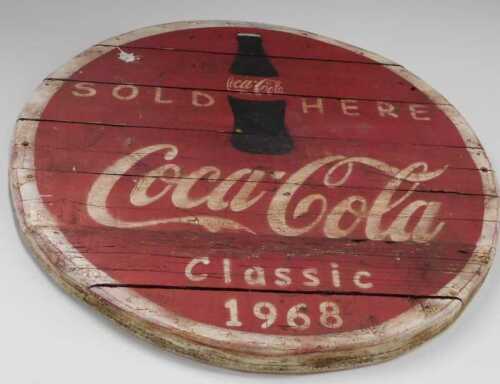 V - A slatted wooden Coca-Cola Sold Here Classic 1968 sign, probably late 20thC, 86cm diameter. NB....