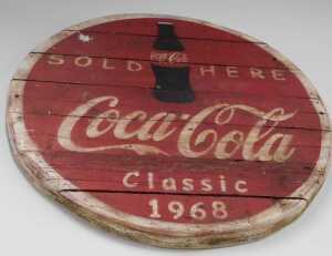V - A slatted wooden Coca-Cola Sold Here Classic 1968 sign, probably late 20thC, 86cm diameter. NB....