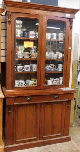 V - A Victorian mahogany bookcase, with moulded cornice raised above two glazed doors flanked by...
