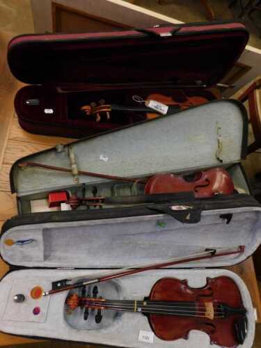 V - Three violins, to include a small practice violin or fiddle, labelled Suzuki, the main body 31cm...