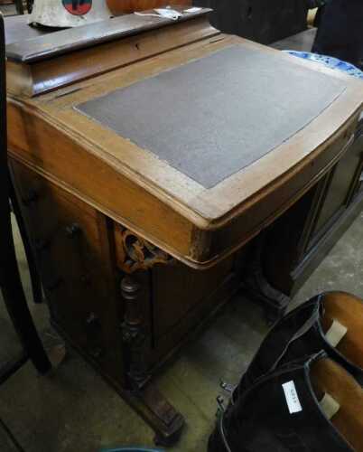 V - A late 19thC mahogany Davenport desk, the hinged lid to the back revealing fitted pigeon holes,...