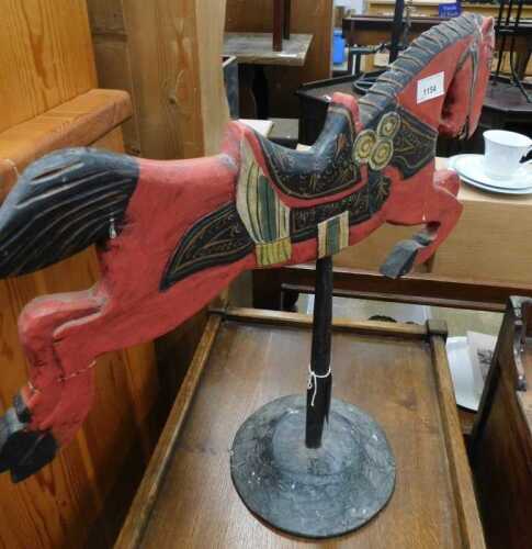 V - A 20thC carved wooden painted model of a horse on stand, 55cm high. NB. VAT is payable on the...