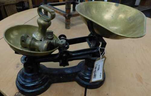 V - A 20thC iron scale, with brass pans and associated weights, with figure-of-eight base, 25cm wide....