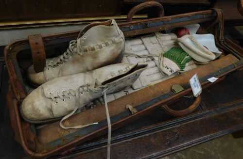 V - Various bygone cricketing items, a mid 20thC leather cricketing bag, 84cm long, cricketing boots,...