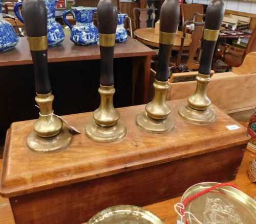 V - Four vintage Blackfriars brass beer pumps, with wooden handles, on a wooden base, 66cm wide. NB....