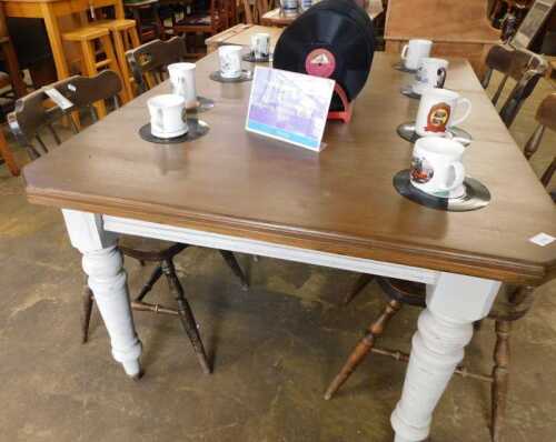 V - A late Victorian extending dining table, with canted top, on turned legs, later painted in cream,...