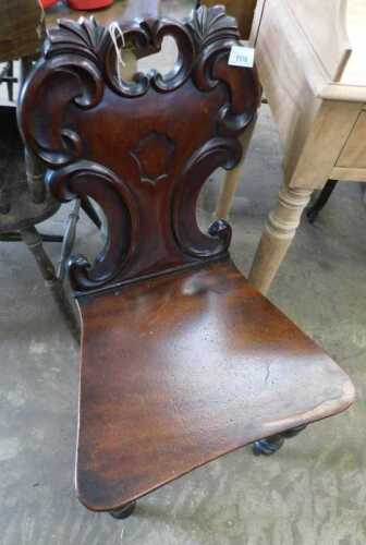 V - A 19thC mahogany hall chair, with inverted scroll backsplat, shaped seat, on turned front and...