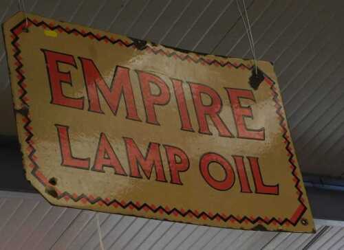 V - A 20thC enamel Empire Lamp Oil advertising sign, with rectangular canted outline, in orange and...