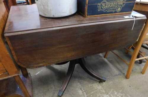 V - An early 19thC mahogany drop-leaf table, with wide crossbanding, on a turned stem terminating in...