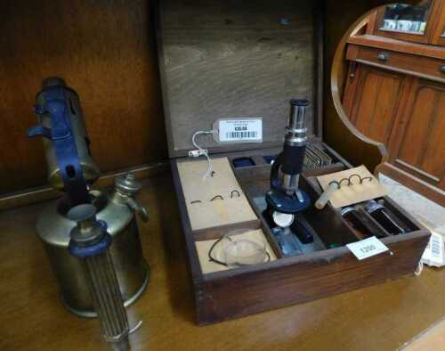 V - A 20thC student microscope, 20cm high, partially cased, and a brass blowtorch. (2) NB. VAT is...