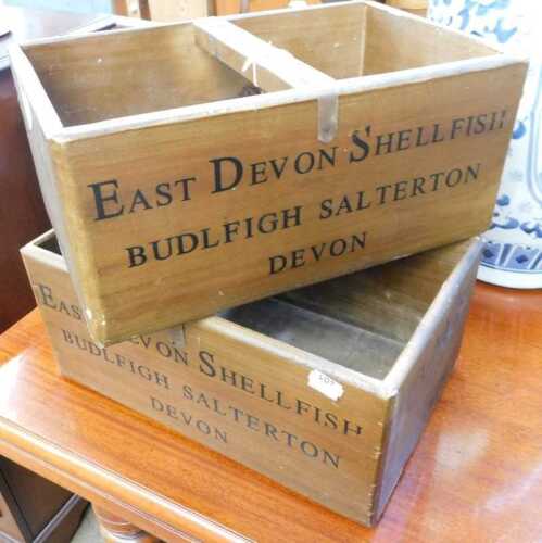 V - Two wooden baskets marked Clams East Devon Shellfish Devon, 36cm wide. (2) NB. VAT is payable on...