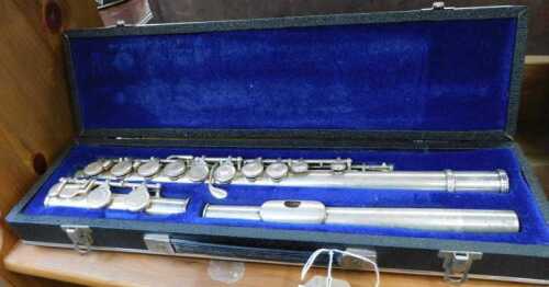V - A 20thC chrome plated three part flute, in fitted case, 42cm wide. NB. VAT is payable on the...