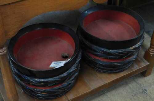 V - Japanese sake bowls, of shaped circular form, with red interiors, 33cm wide. NB. VAT is payable...
