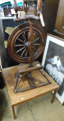 V - A late 19thC/early 20thC oak country spinning wheel, with turned mounts on a shaped base on...
