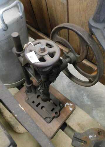 V - An early 20thC iron table-top pillar drill, with articulated handle, 63cm high. NB. VAT is...