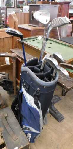 V - A Longridge golf bag, 85cm high, containing a quantity of golf clubs, including Callaway, Big...