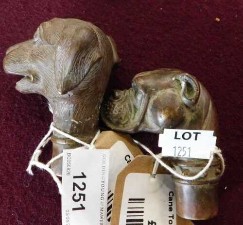 V - A cane topper in the form of a dog's head, 8cm high, and another. (2) NB. VAT is payable on the...