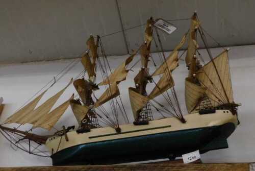 V - A 20thC wooden model of a galleon, with realistic decking, rigging and masts, on a wooden stand,...