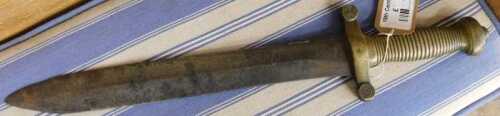 V - A short sword, with a shaped blade, having a turned brass handle, compressed pommel, 49cm long....